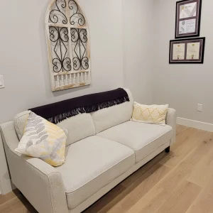 Client waiting area with sofa at RazorFree Electrolysis Nanaimo